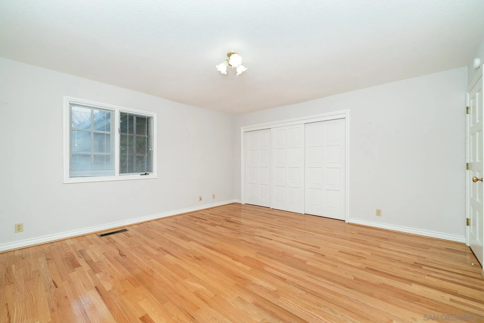 2908 Lakemont Drive Fallbrook, CA 92028 - Photo 21 of 70 a view of empty room with wooden floor and fan