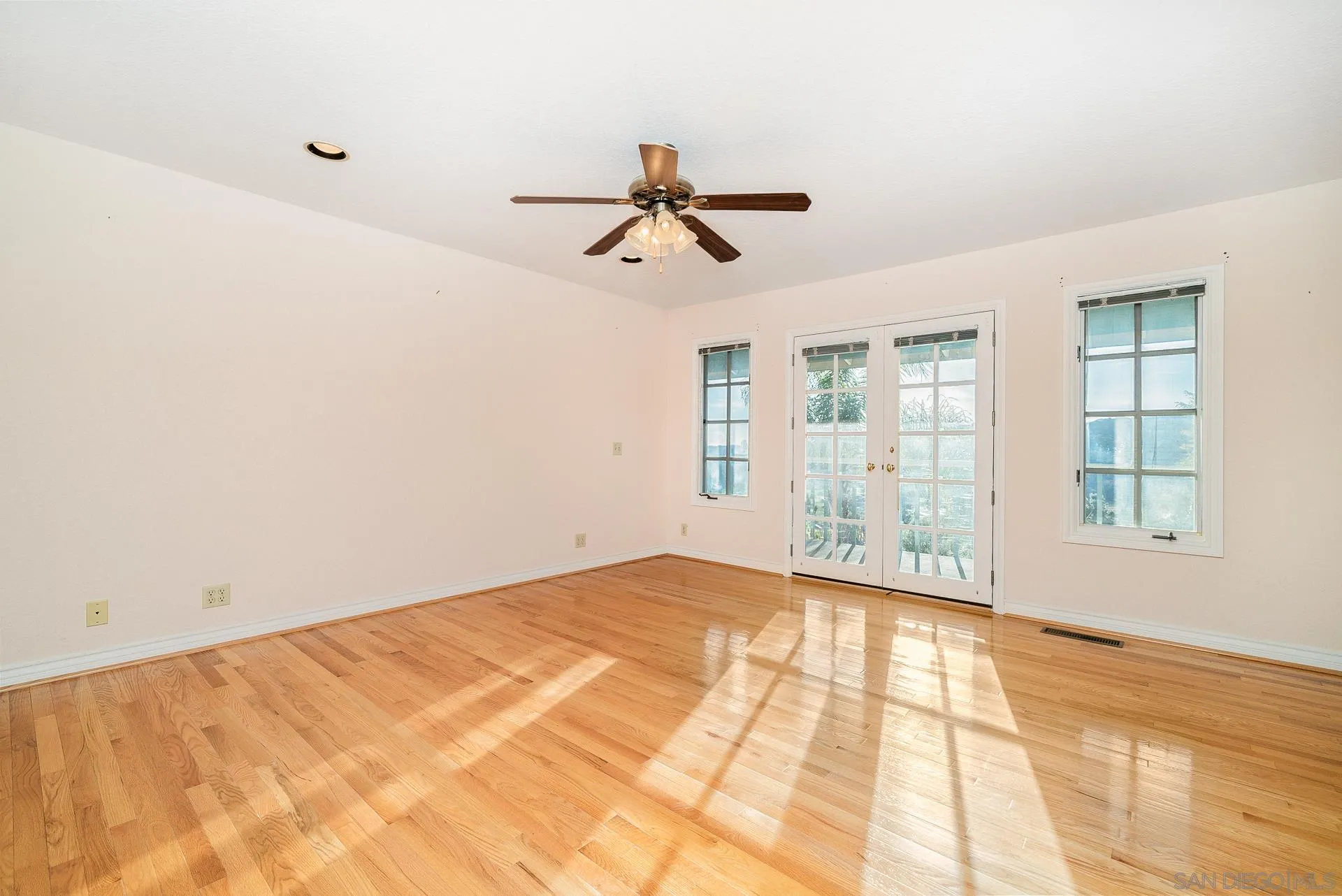 2908 Lakemont Drive Fallbrook, CA 92028 - Photo 27 of 70 a view of empty room with wooden floor and fan