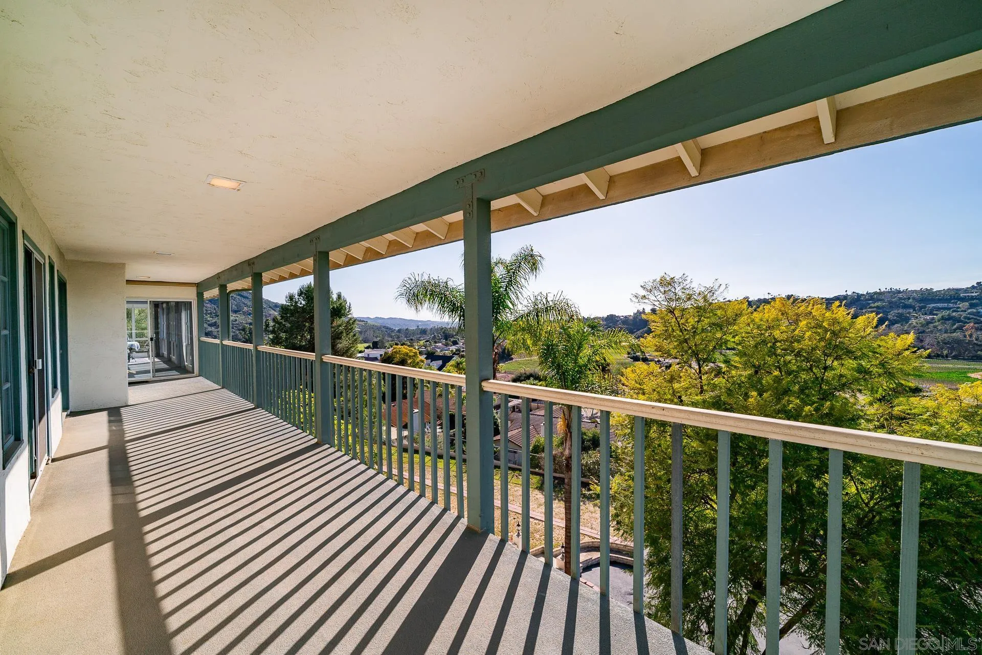 2908 Lakemont Drive Fallbrook, CA 92028 - Photo 33 of 70 a balcony with wooden floor next to a yard
