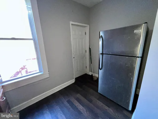 a view of a room with wooden floor and a window