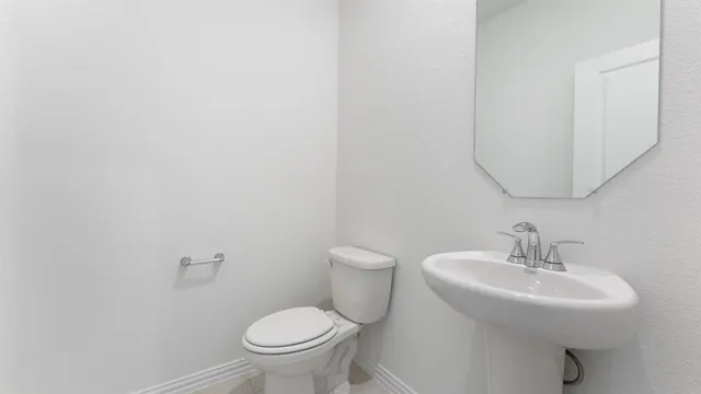 a bathroom with a sink toilet and a mirror