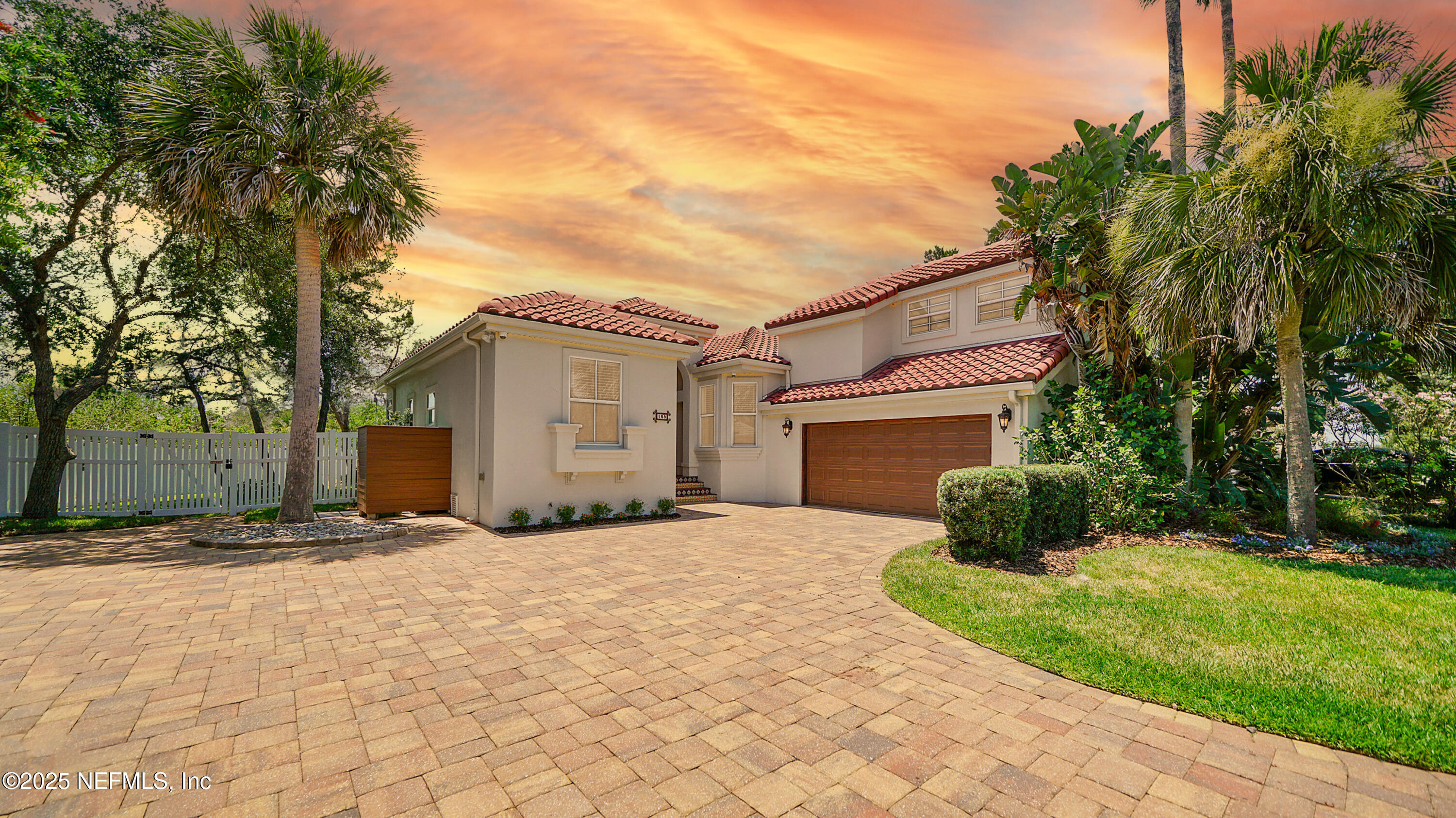 a front view of a house with a yard and a garage