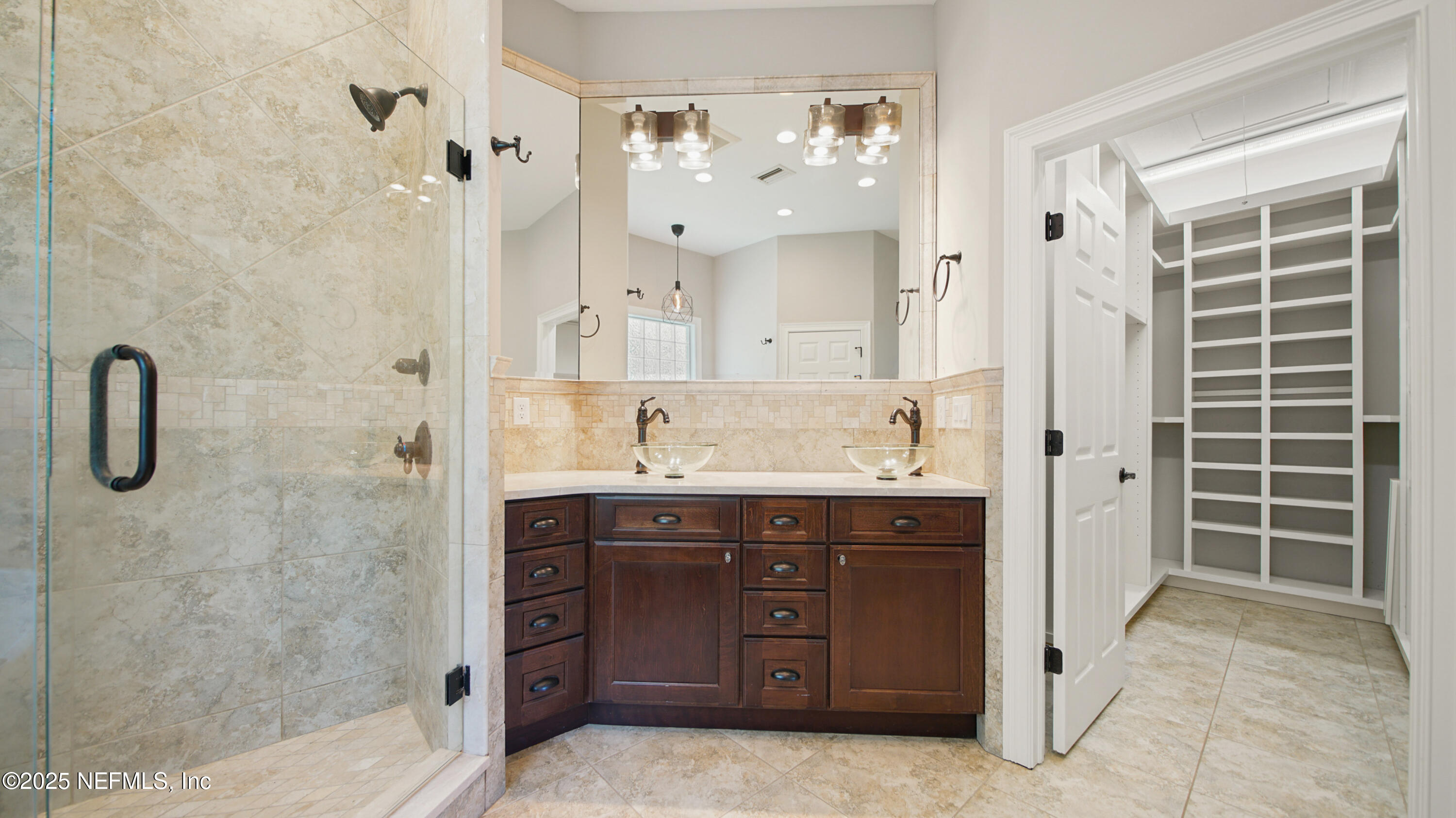 108 Spoonbill Point Court St. Augustine, FL 32080 - Photo 20 of 57 a spacious bathroom with a shower sink and mirror