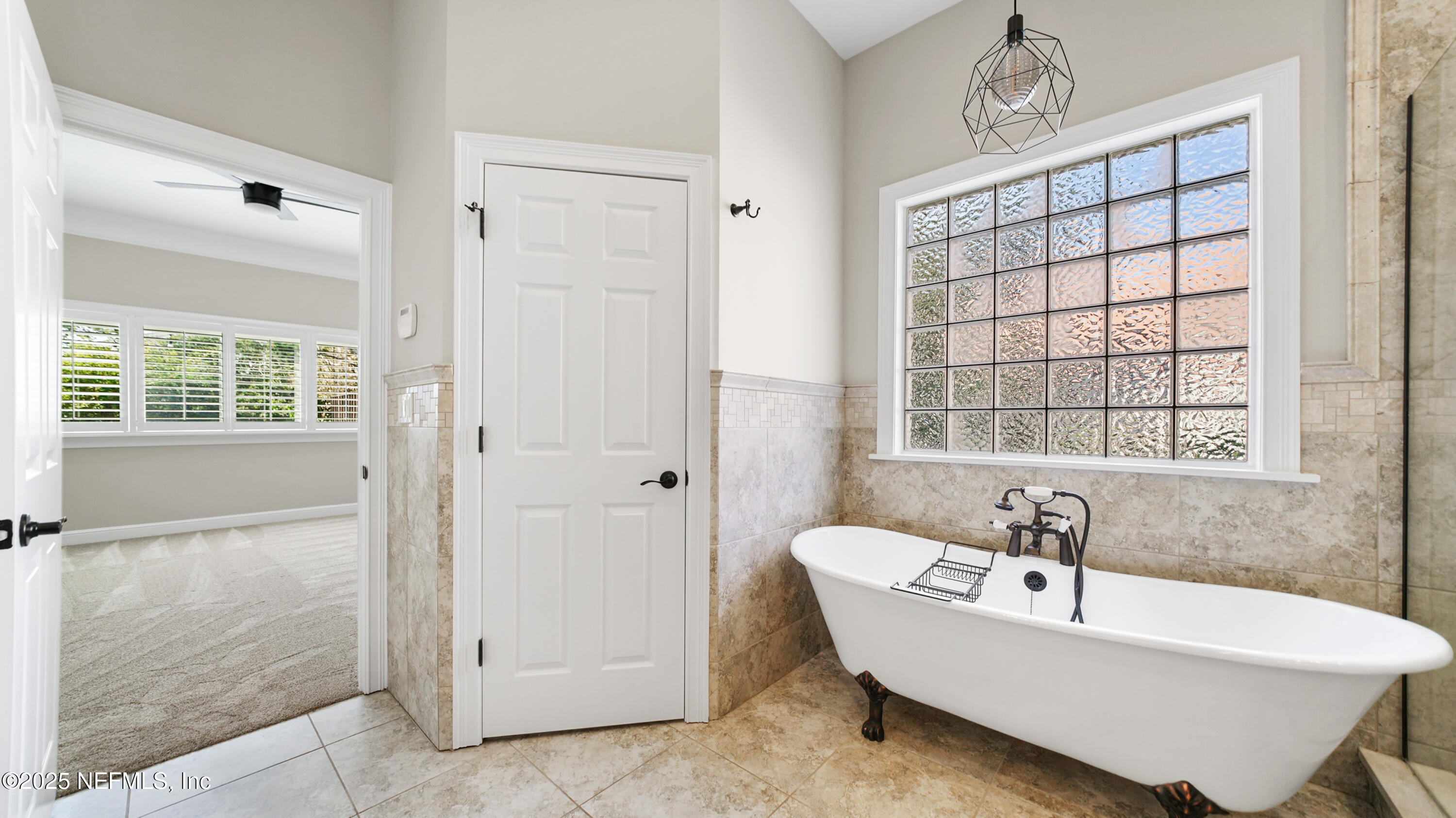 108 Spoonbill Point Court St. Augustine, FL 32080 - Photo 23 of 57 a bathroom with a bathtub and a shower