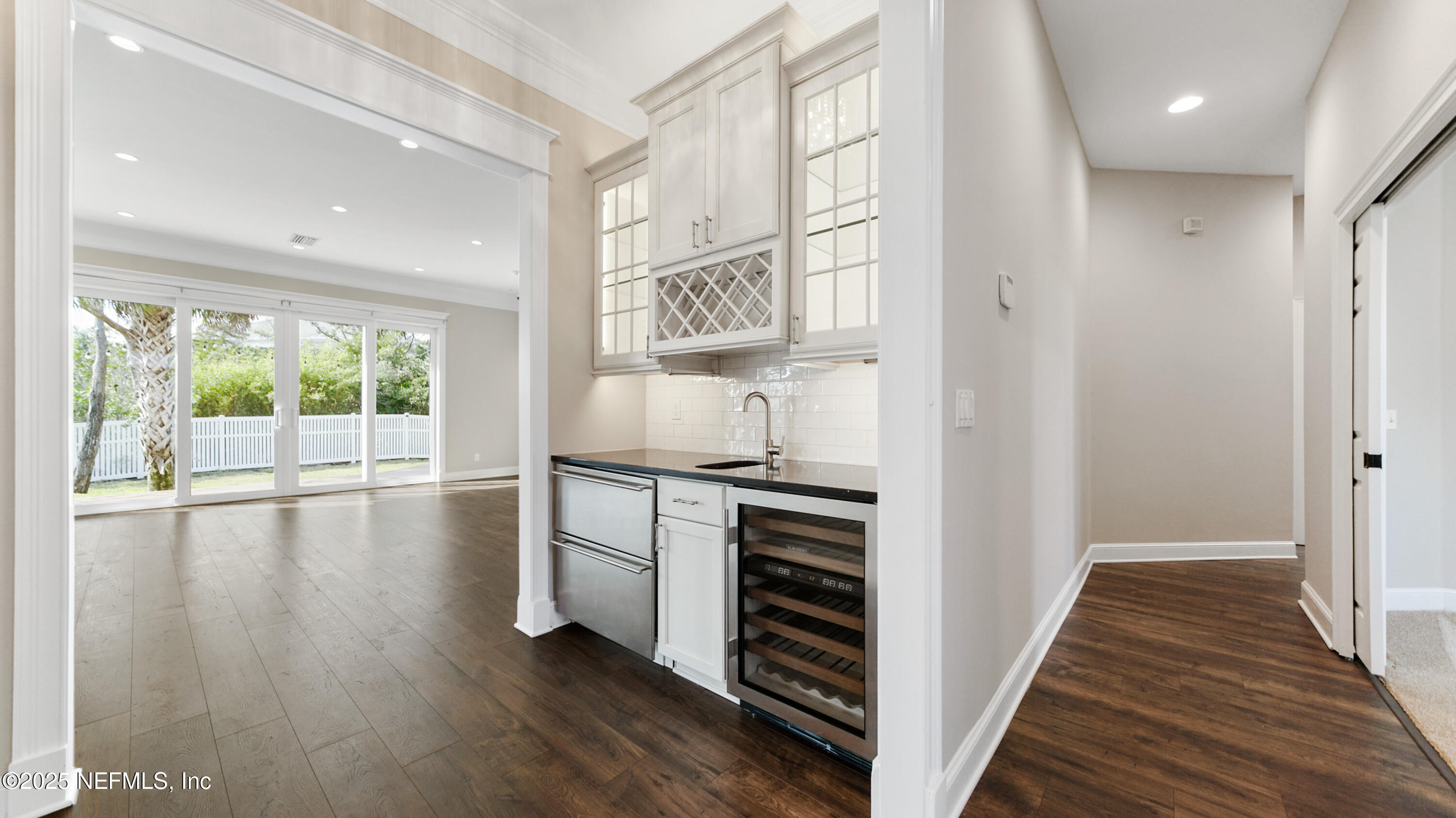 108 Spoonbill Point Court St. Augustine, FL 32080 - Photo 5 of 57 a view of a kitchen from the hallway with wooden floor and staircase