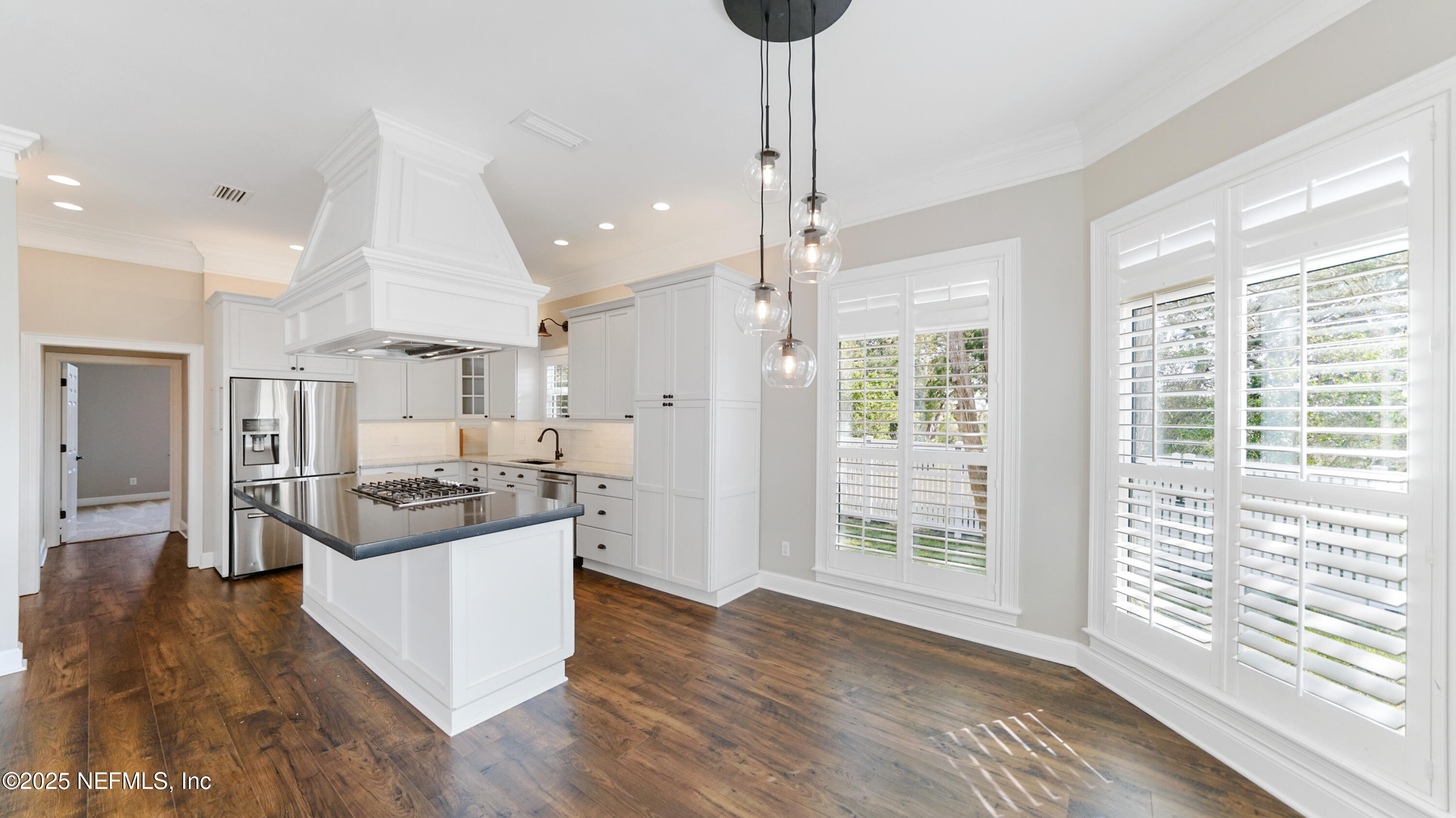 108 Spoonbill Point Court St. Augustine, FL 32080 - Photo 7 of 57 a large kitchen with kitchen island a large counter top and stainless steel appliances