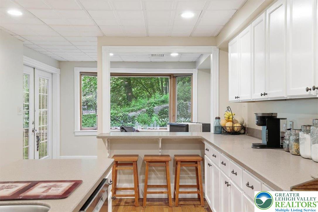 3585 Fairyland Road Lehighton, PA 18235 - Photo 24 of 57 a kitchen with stainless steel appliances white cabinets and a large window