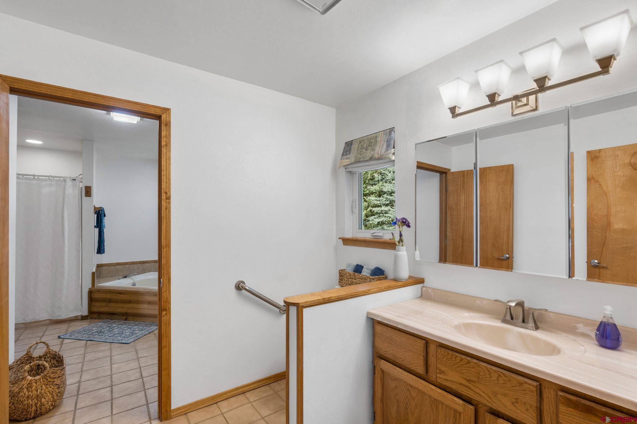 37 Verde Lane Durango, CO 81301 - Photo 21 of 45 a en suite bathroom with a sink and a mirror