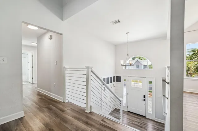 a view of empty room with fireplace and wooden floor