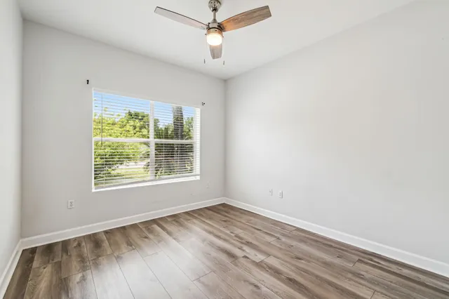 a kitchen with stainless steel appliances granite countertop a sink a stove a microwave and wooden cabinets