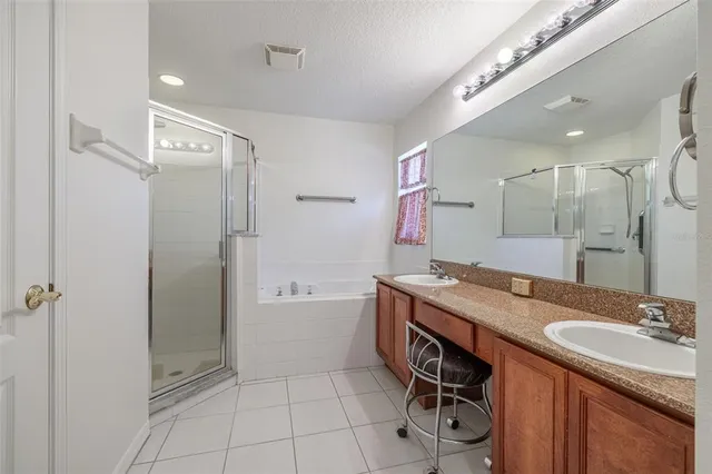 a bathroom with a granite countertop sink a mirror and a bathtub
