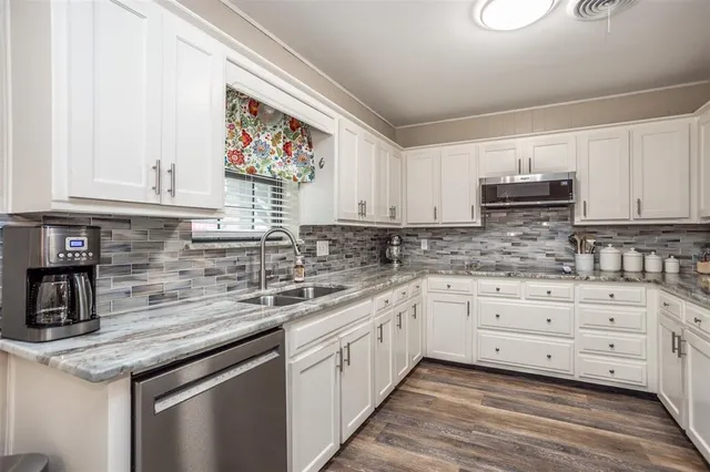 a kitchen with granite countertop a sink and a granite counter tops