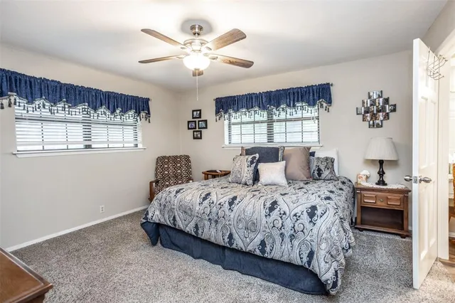 a bedroom with a large bed and a chandelier