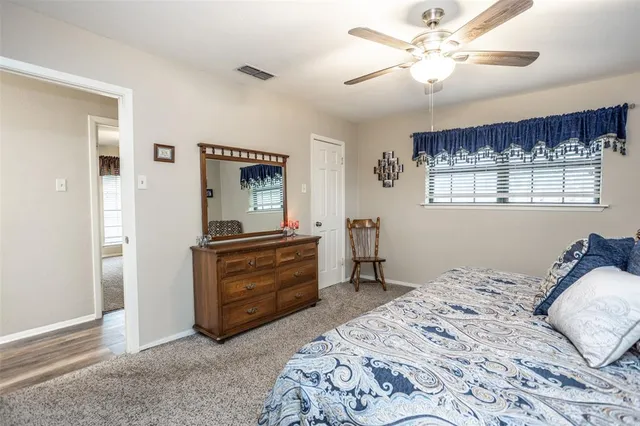 a bathroom with a granite countertop sink a toilet and a mirror
