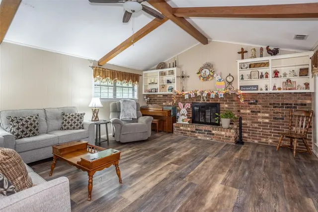 a living room with fireplace furniture and a fireplace