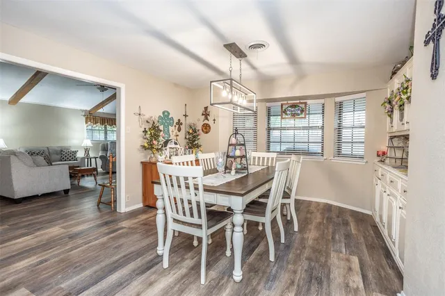 a kitchen with granite countertop white cabinets and stainless steel appliances