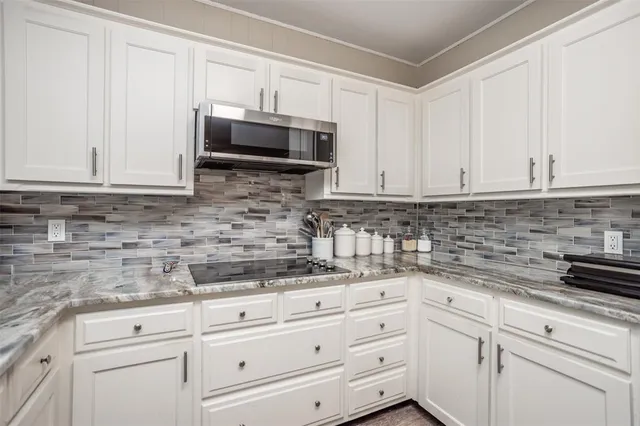 a kitchen with stainless steel appliances a refrigerator sink and cabinets