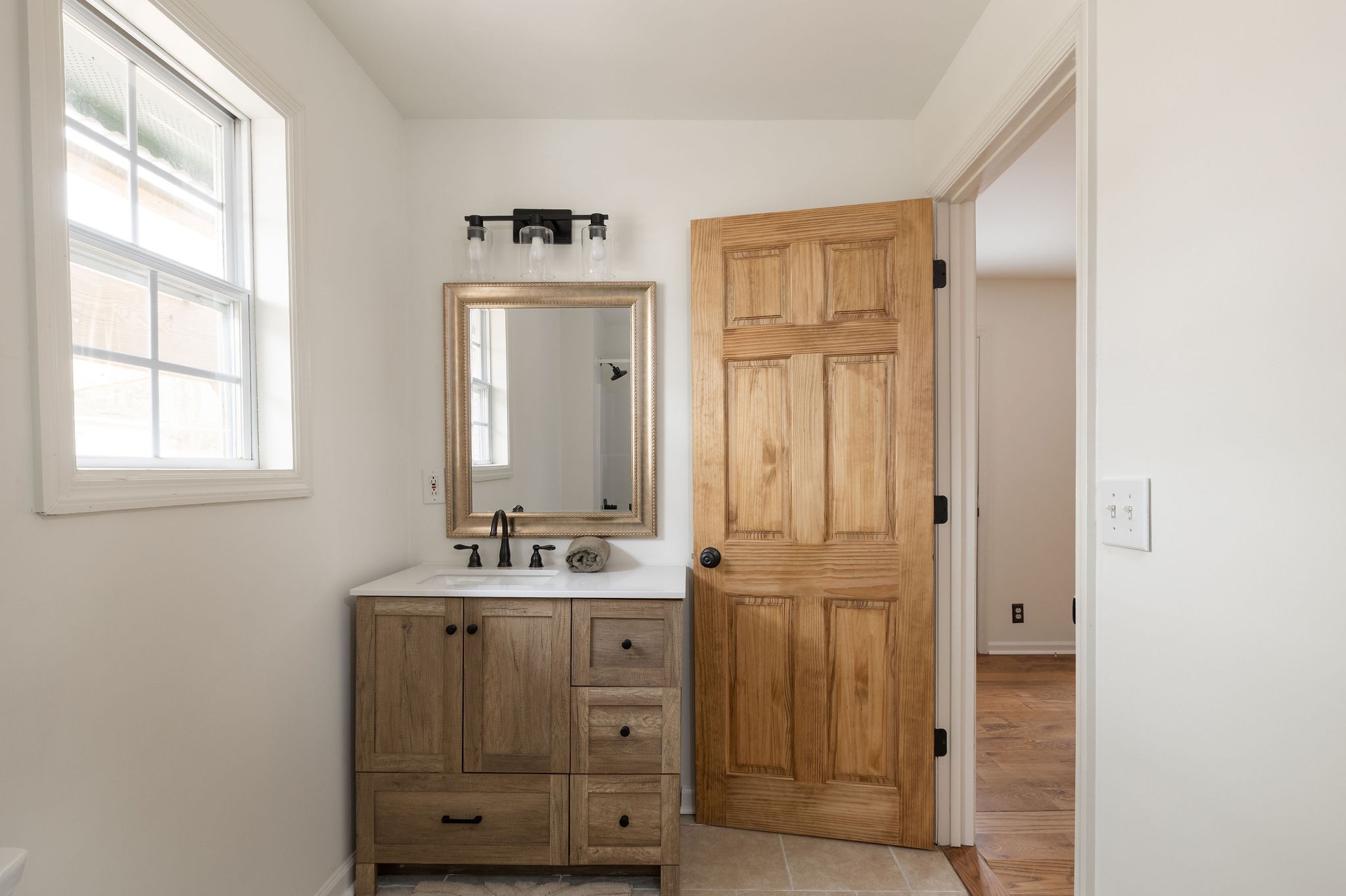 1826 New Hope Road Joelton, TN 37080 - Photo 33 of 95 a bathroom with a sink a mirror and a window