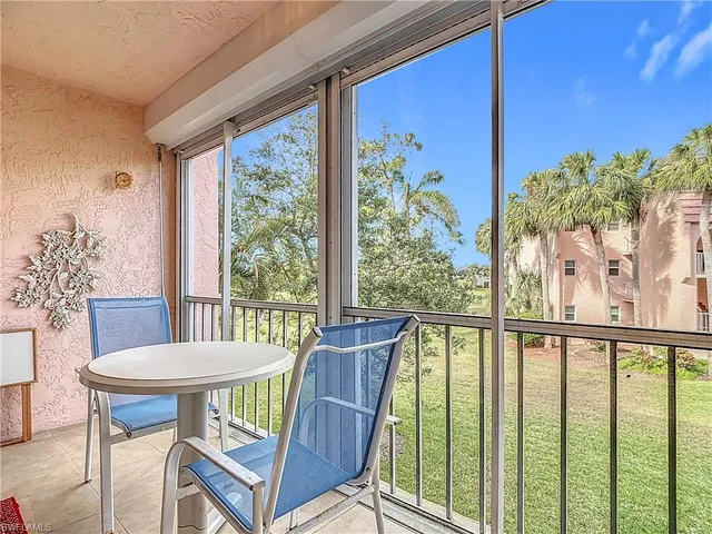 a view of a porch with furniture and a potted plant