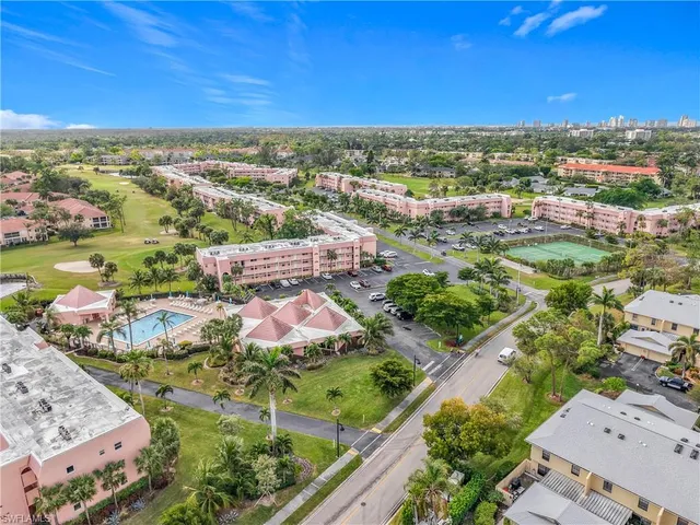 an aerial view of residential houses with outdoor space and swimming pool