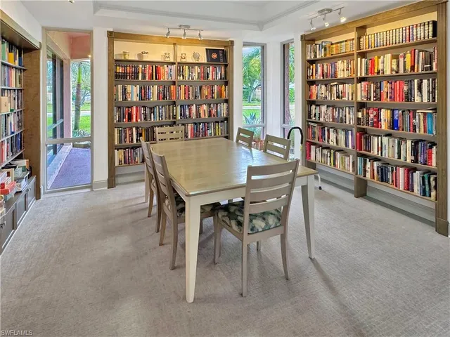 a dining room with furniture and a book shelf