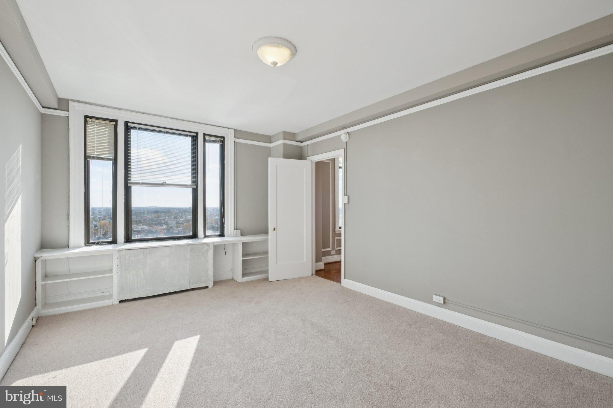 2031 Locust Street, Unit 1402 Philadelphia, PA 19103 - Photo 5 of 15 an empty room with windows