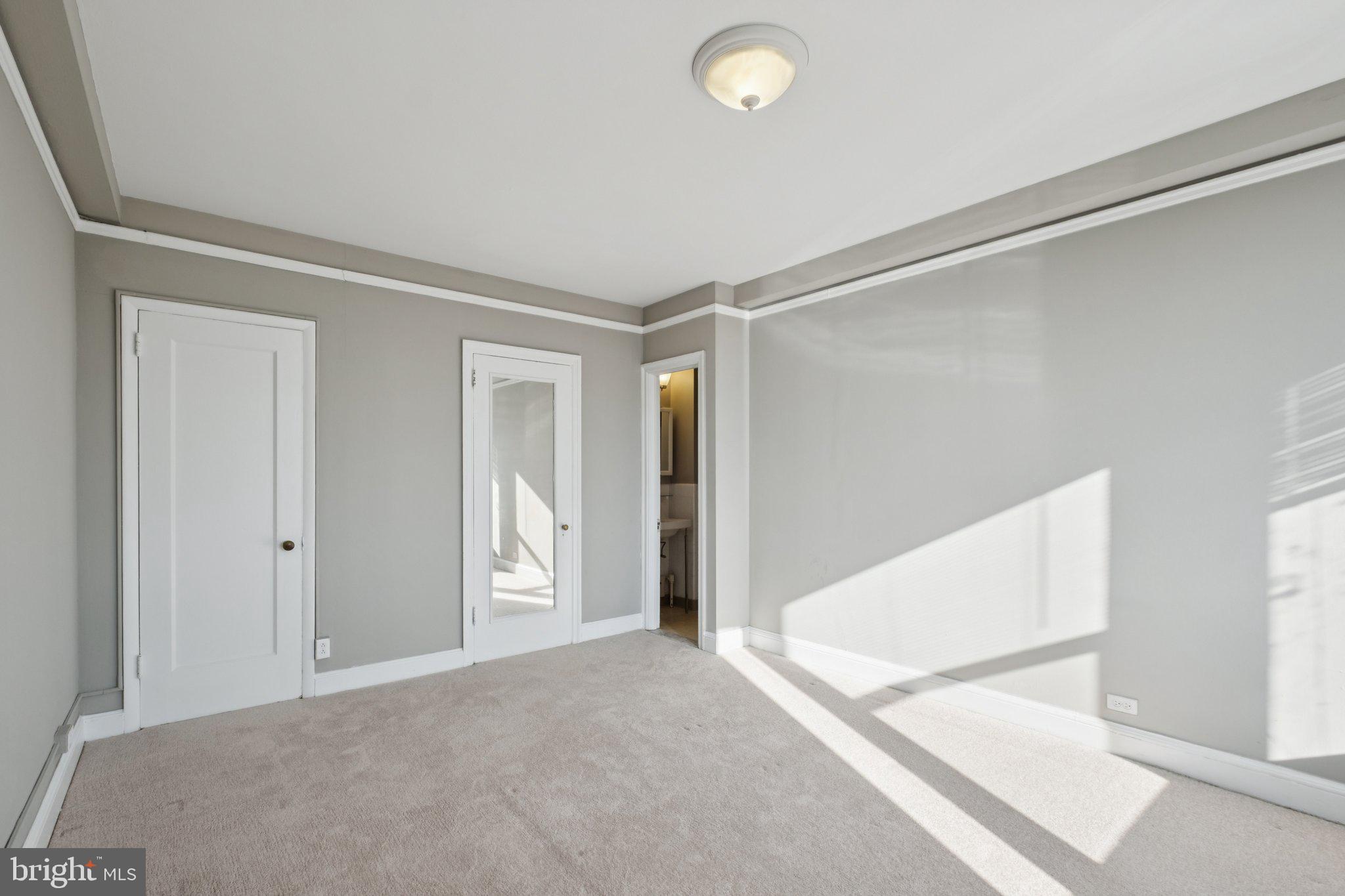 2031 Locust Street, Unit 1402 Philadelphia, PA 19103 - Photo 6 of 15 a view of a big room with closet and windows