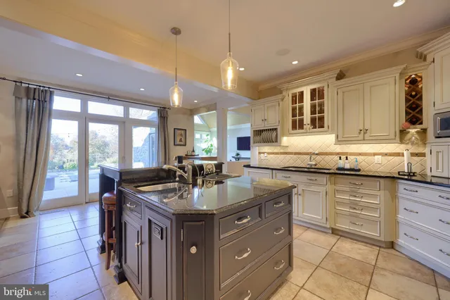 a kitchen with stainless steel appliances granite countertop a stove refrigerator and cabinets