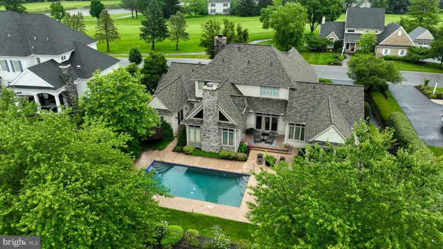 a living room with furniture fireplace and a large window