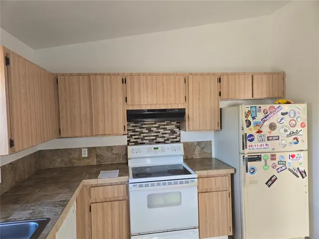 an empty room with a bathroom and a sink