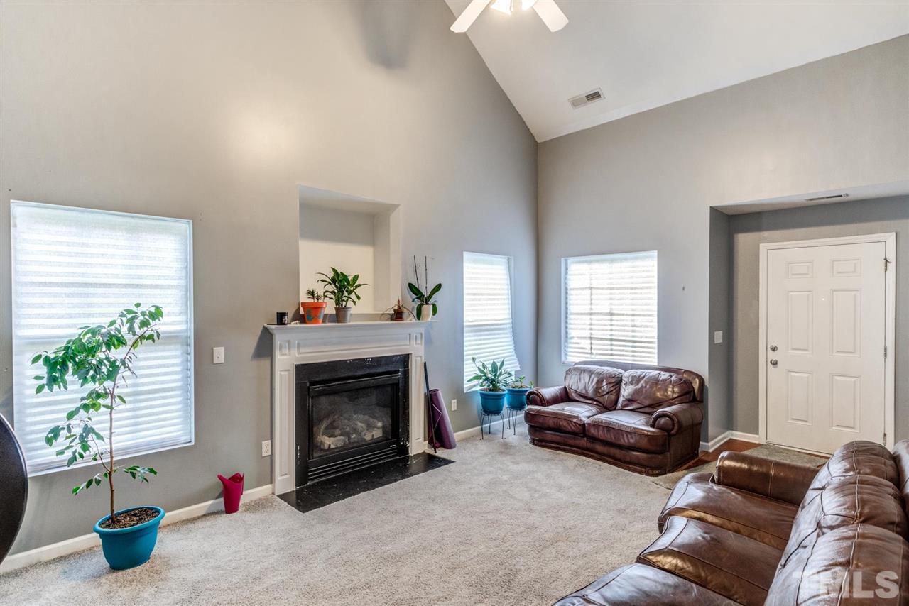 3713 Cyrus Street Raleigh, NC 27610 - Photo 6 of 30 Huge ceilings bring tons of light in the open Great room - complete with gas log fireplace
