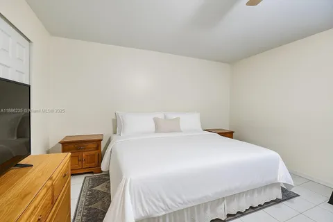 a bedroom with a bed and a television