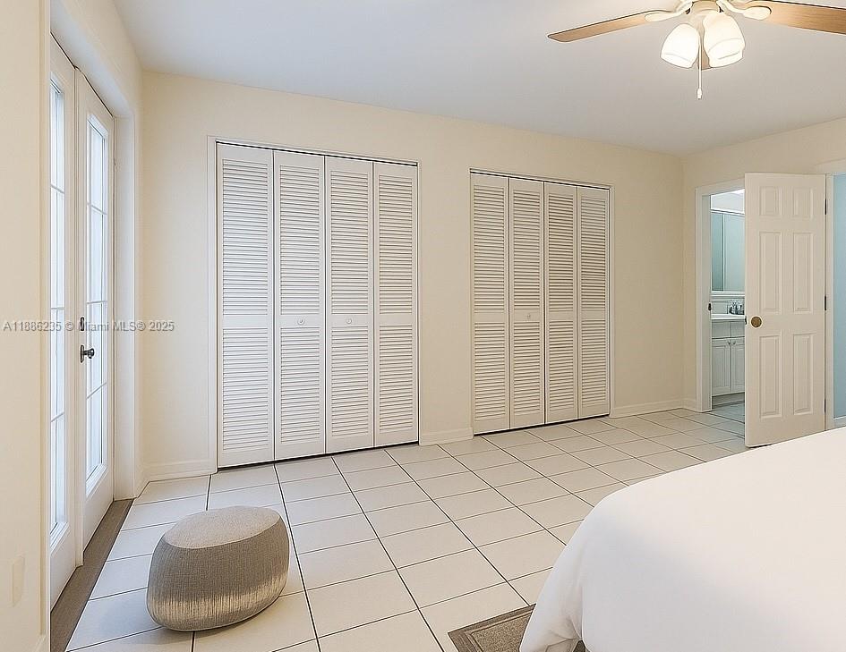 27 Madrid Lane, Unit 28 Davie, FL 33324 - Photo 13 of 34 a spacious bedroom with a bed and a chair