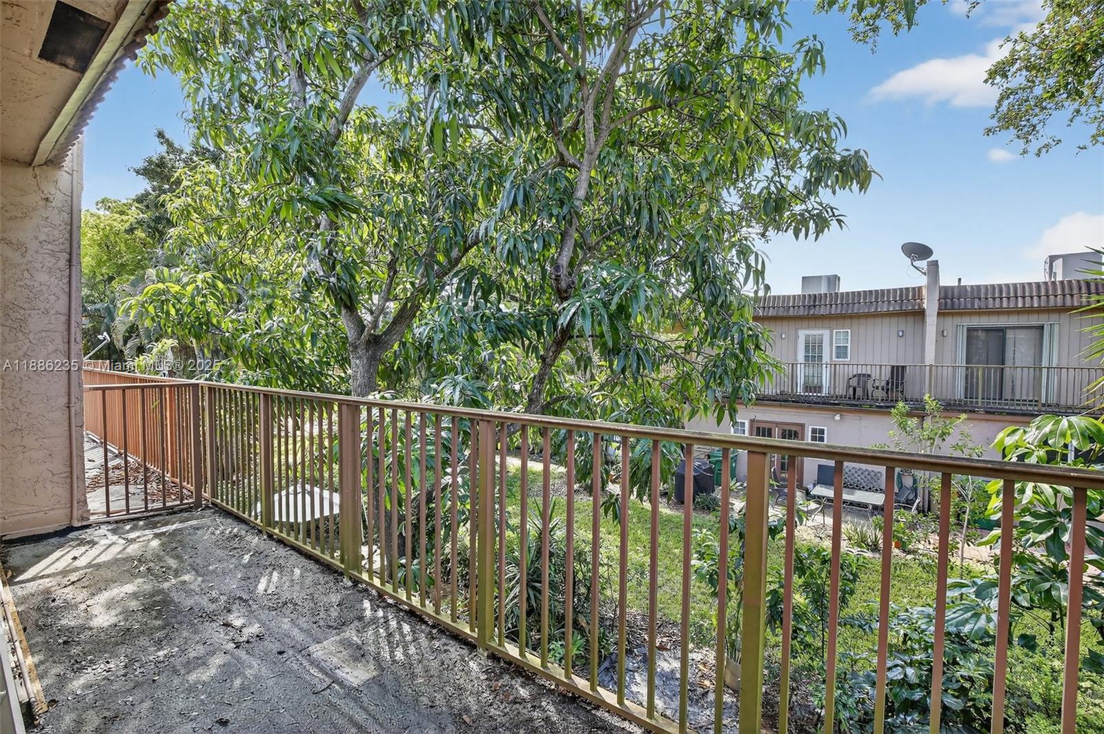 27 Madrid Lane, Unit 28 Davie, FL 33324 - Photo 14 of 34 a balcony with trees in front of it