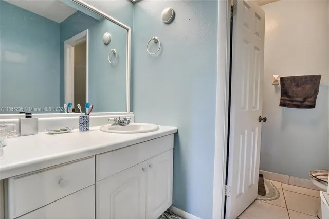 a bathroom with a double vanity sink and mirror