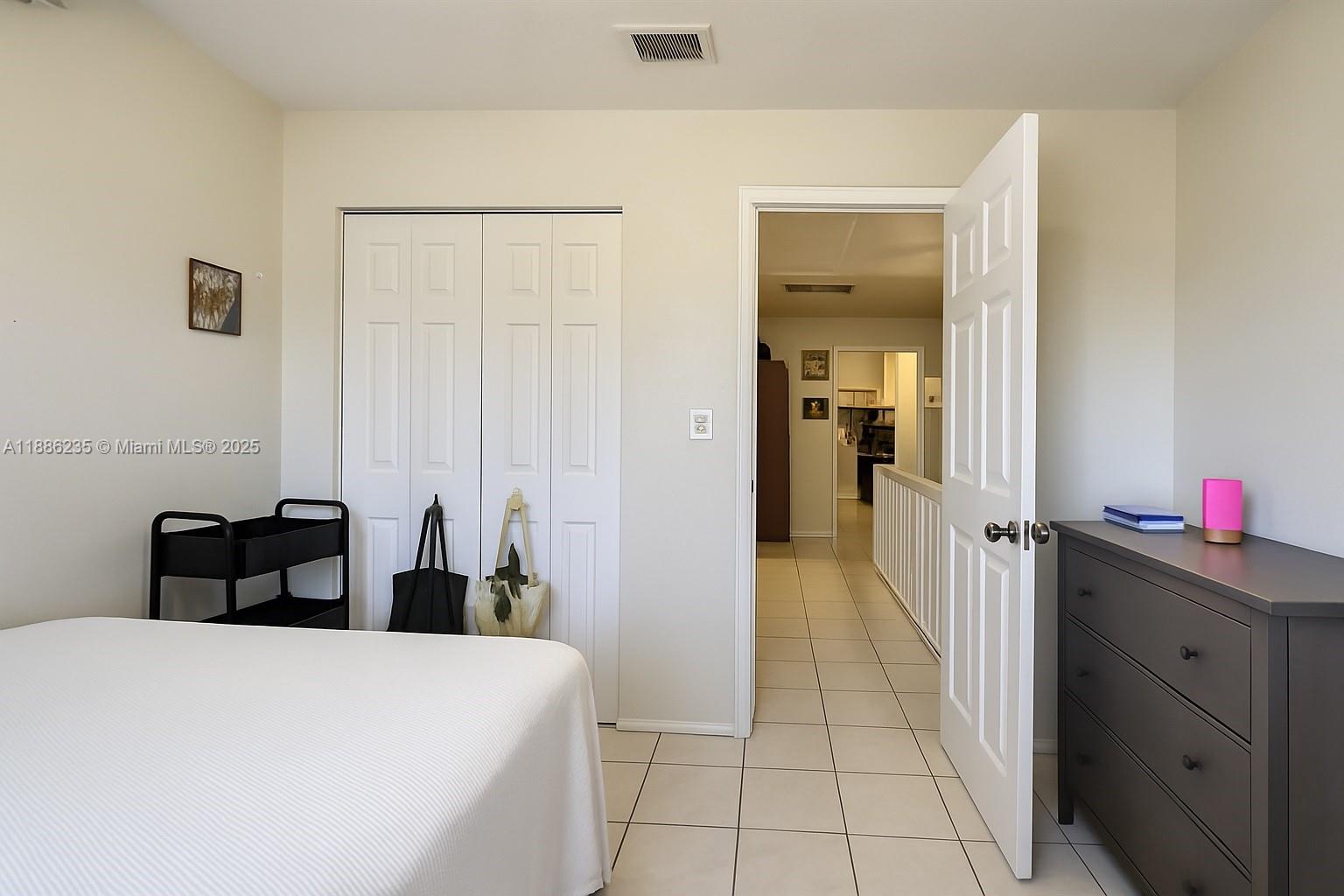 27 Madrid Lane, Unit 28 Davie, FL 33324 - Photo 16 of 34 a bedroom with a bed and a cabinets