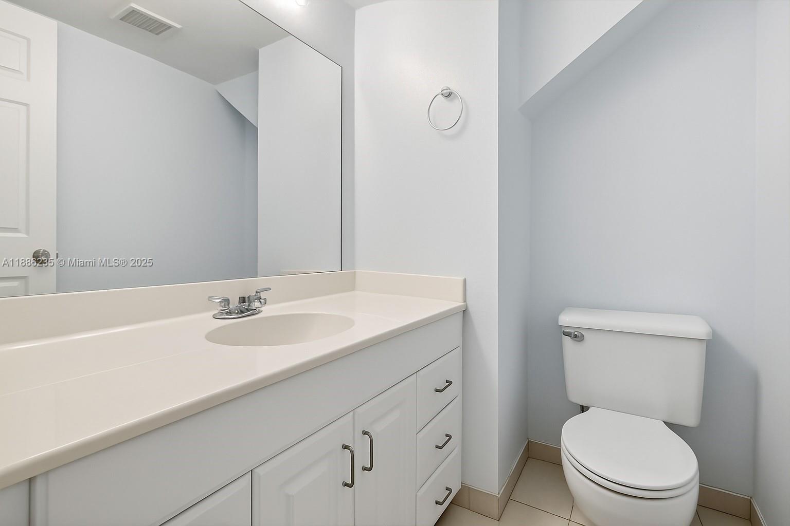 27 Madrid Lane, Unit 28 Davie, FL 33324 - Photo 18 of 34 a bathroom with a toilet sink vanity granite and mirror