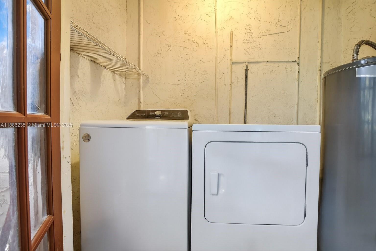 27 Madrid Lane, Unit 28 Davie, FL 33324 - Photo 22 of 34 a utility room with dryer and washer