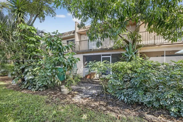 front view of a house with a tree