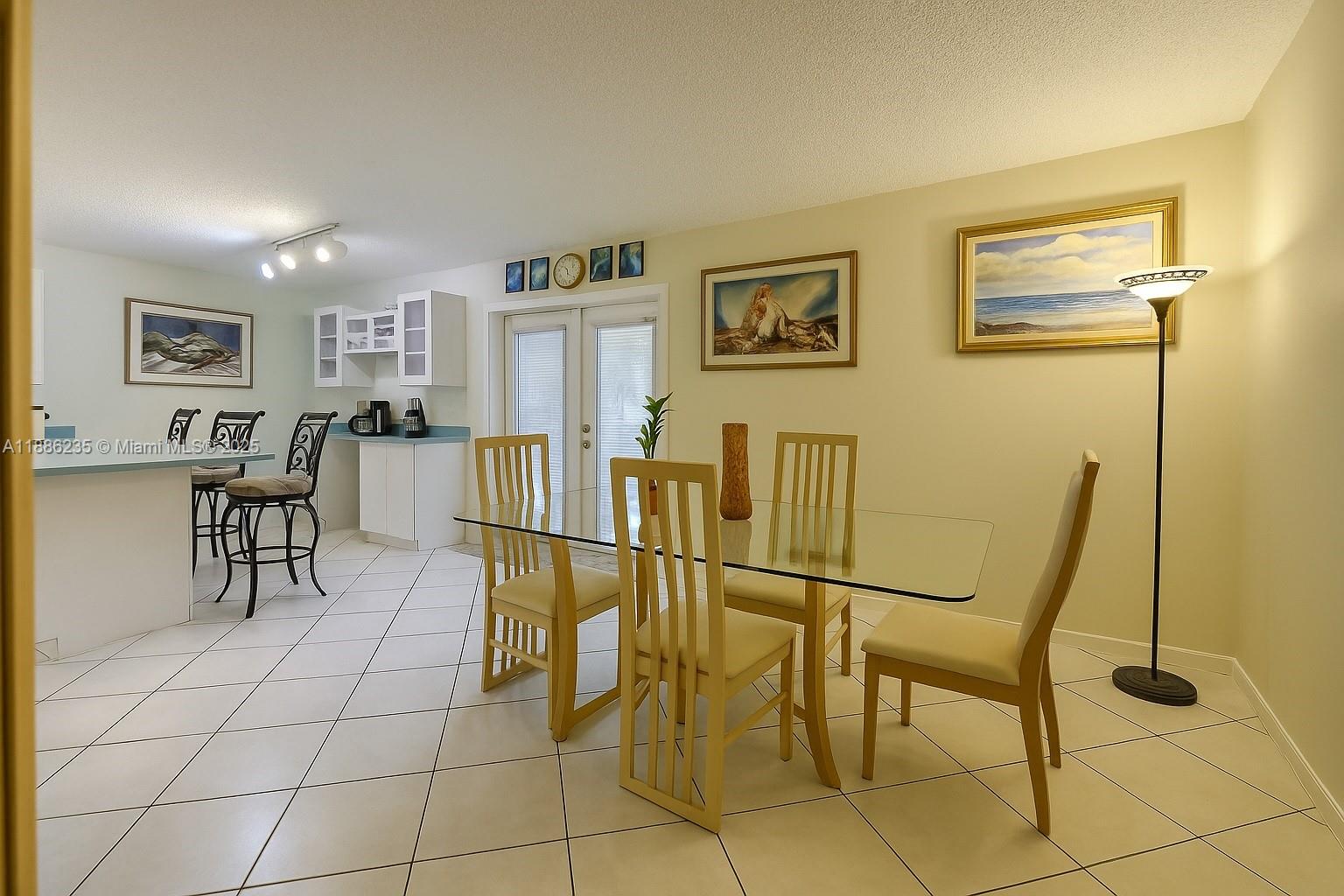 27 Madrid Lane, Unit 28 Davie, FL 33324 - Photo 9 of 34 a view of a dining room with furniture