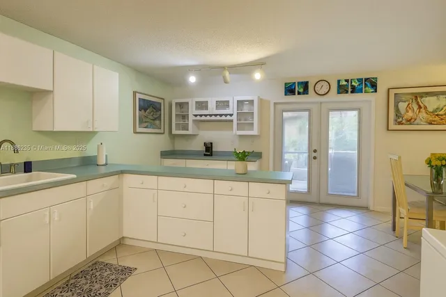 a kitchen with a sink and cabinets