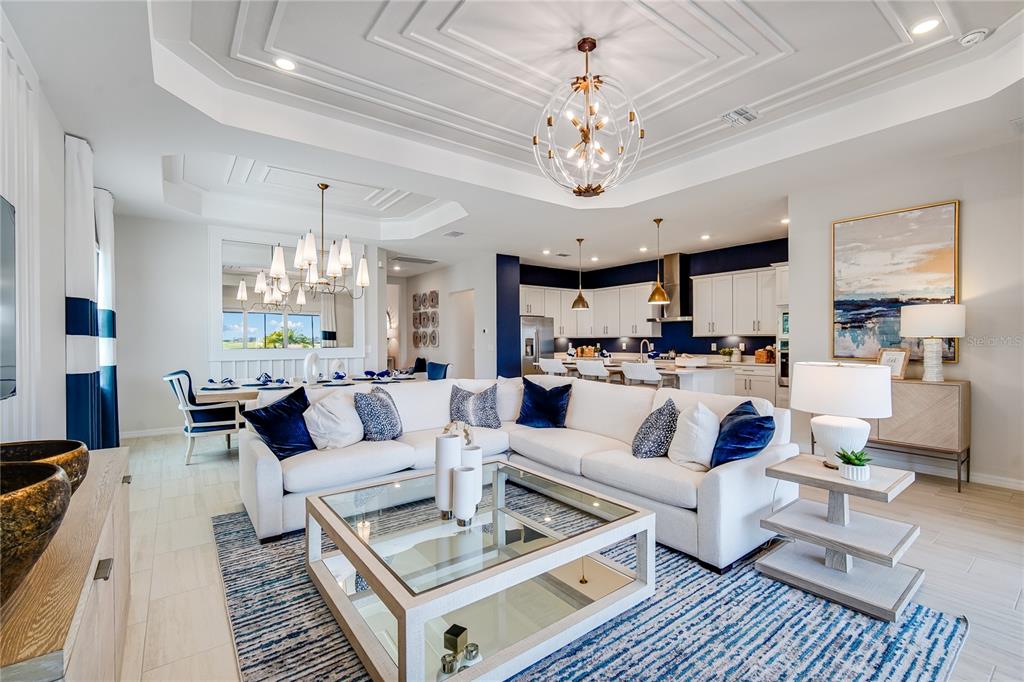 7165 Inlet Isles Lakewood Ranch, FL 34202 - Photo 2 of 26 a living room with lots of furniture and a chandelier