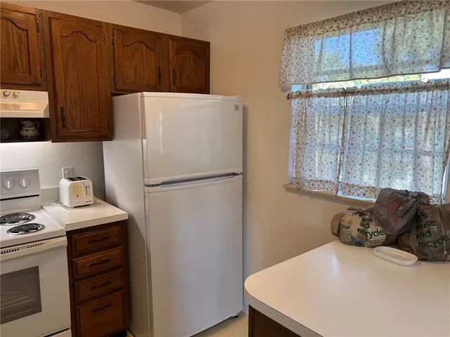 a white refrigerator freezer sitting in a kitchen