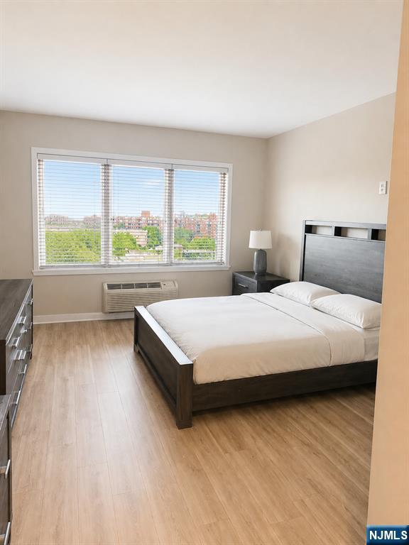 3418 City Place, Unit 3418 Edgewater, NJ 07020 - Photo 4 of 10 a bedroom with a large bed and a large window