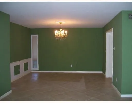 a view of an empty room with window and stairs