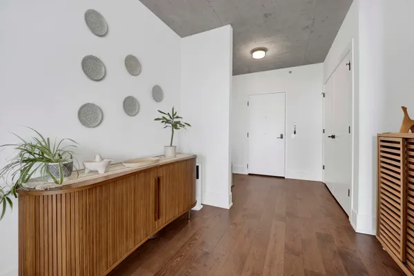 a view of an entryway with wooden floor