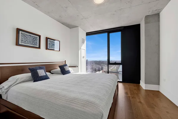 a bedroom with a large bed and a large window