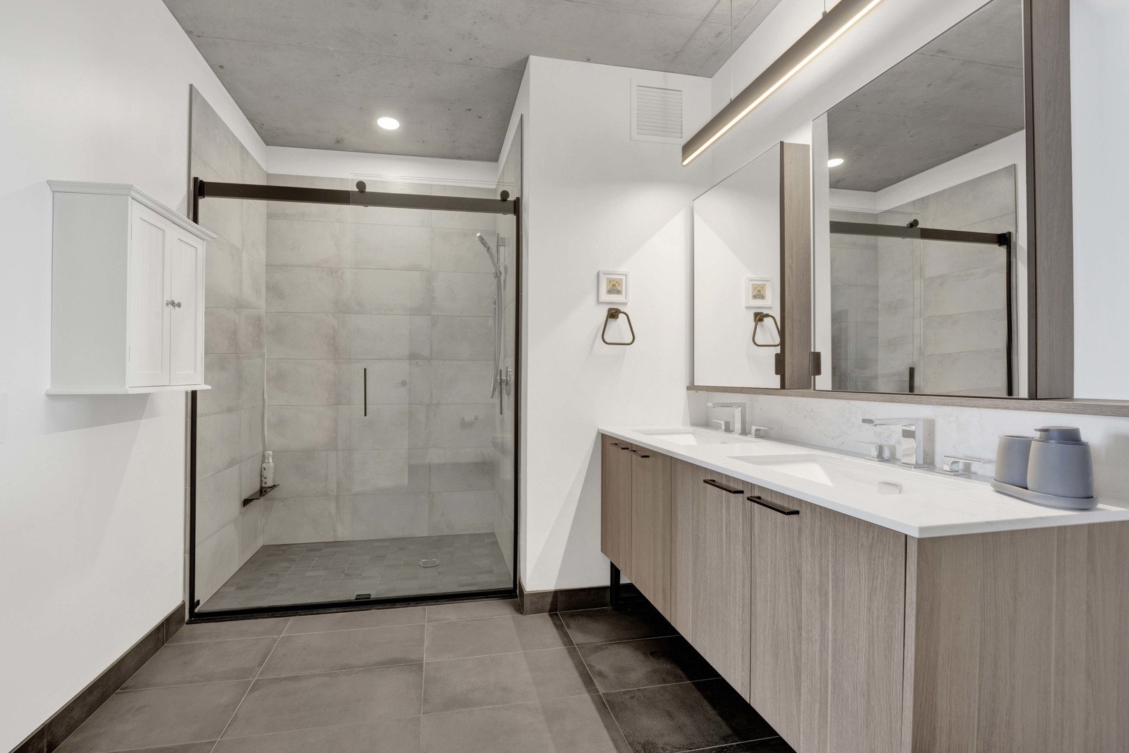 234 West Polk Street, Unit 2903 Chicago, IL 60607 - Photo 17 of 39 a bathroom with a double vanity sink and mirror