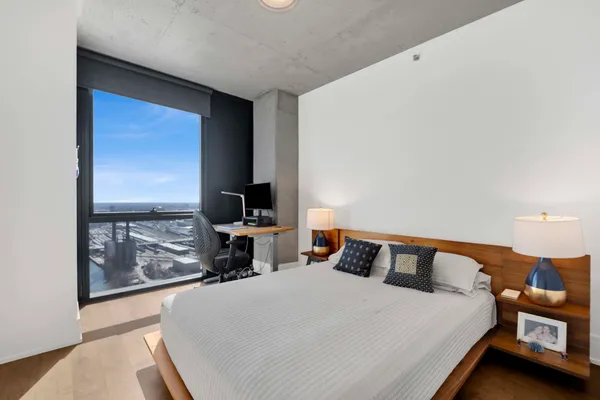 a bed sitting in a bedroom next to a window