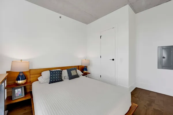 a bedroom with a bed and a lamp